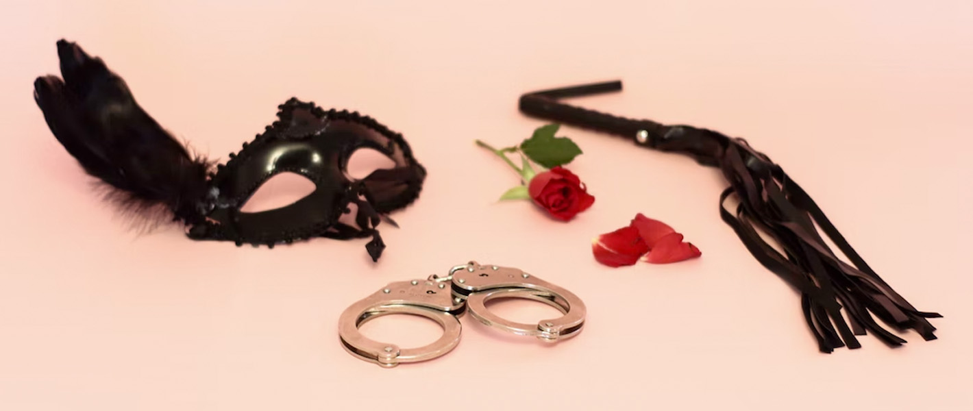 BDSM items on pink background