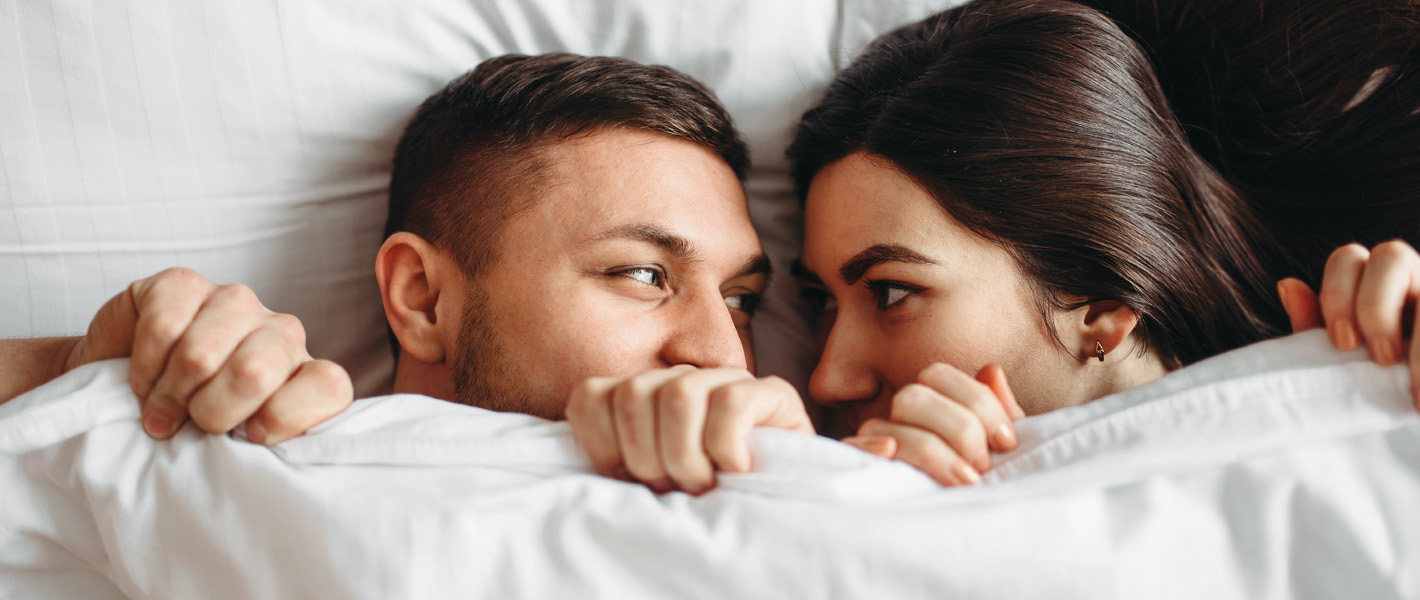 couple under covers in bed