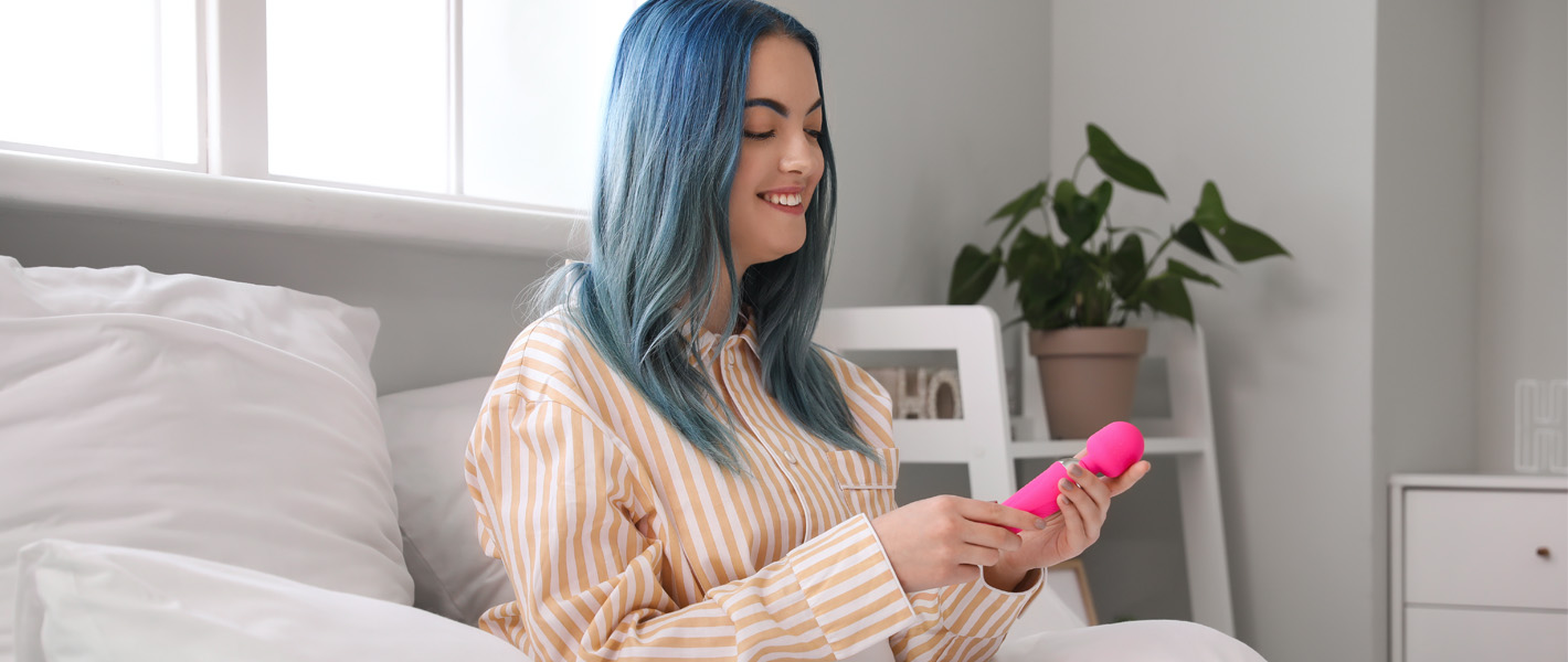 woman holding wand sex toy