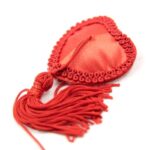 Close up fabric red nipple tassles