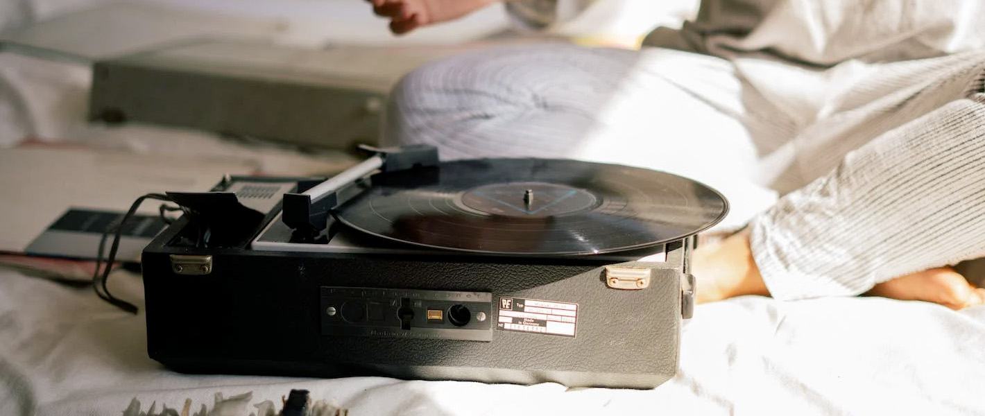 record player next to couple in bed