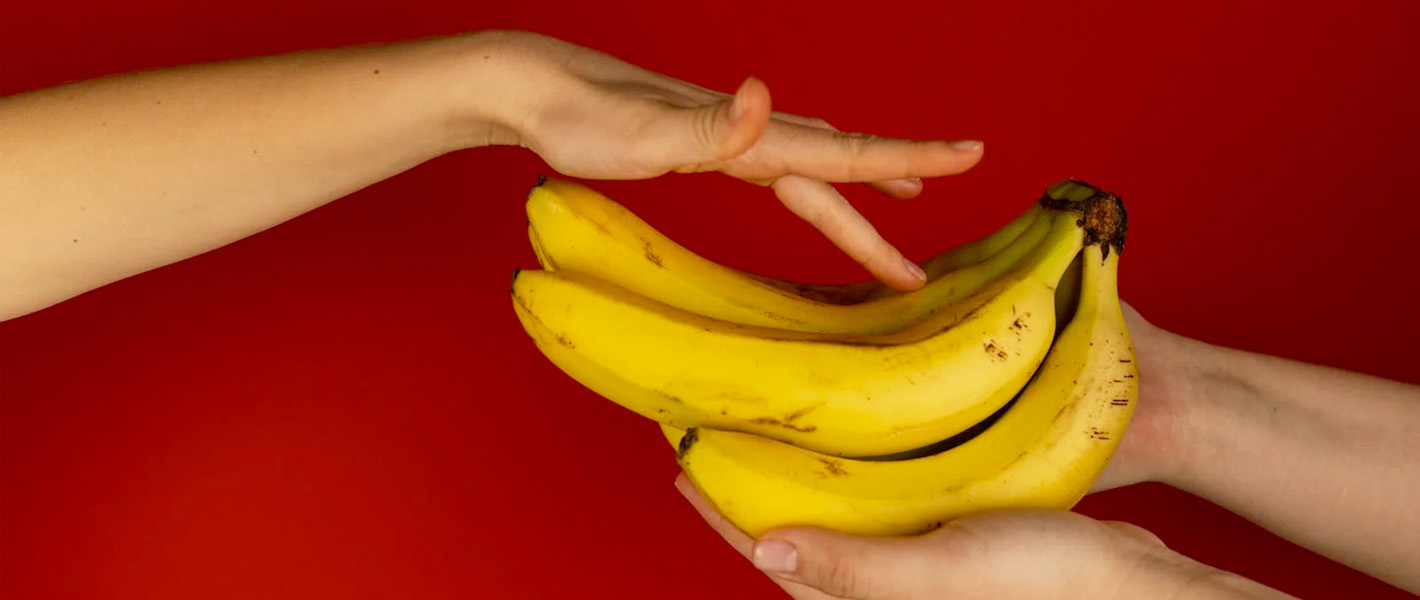 hand touching bananas