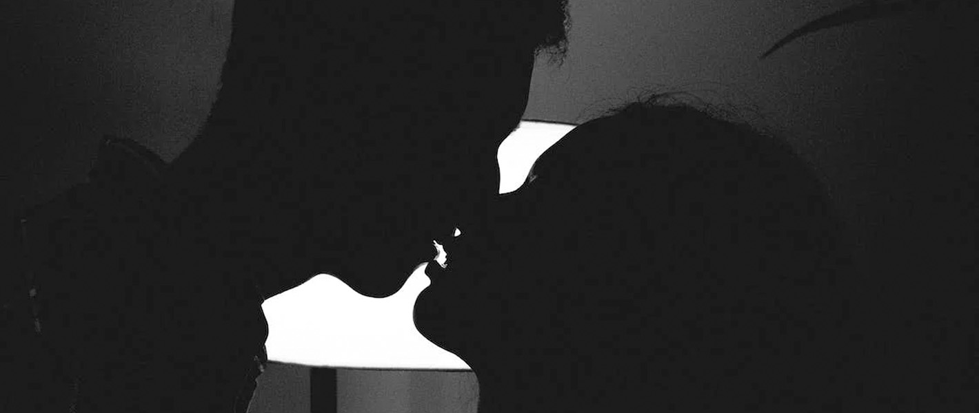 couple kissing in darkness