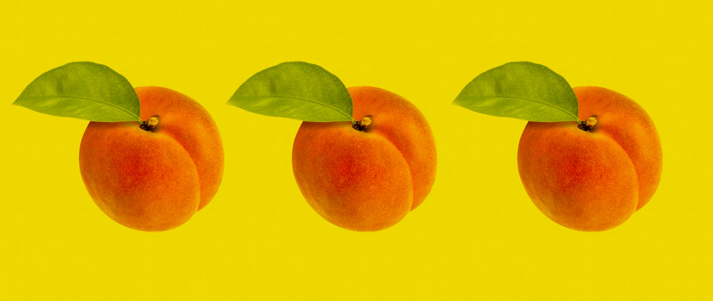 3 peaches against yellow background