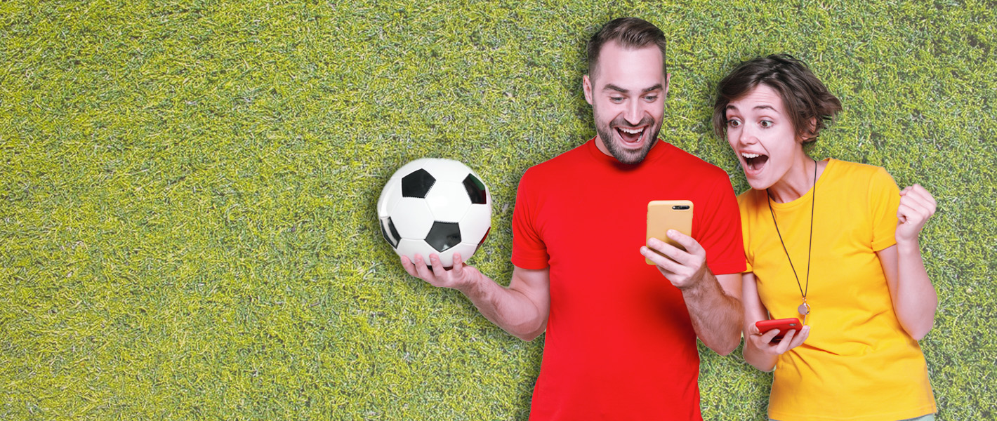 couple holding a football against grass background