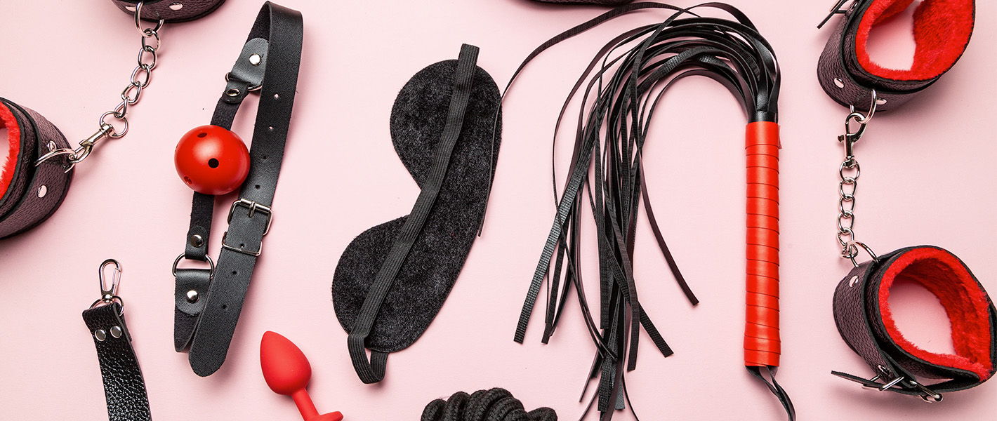 selection of bondage items against a pink background