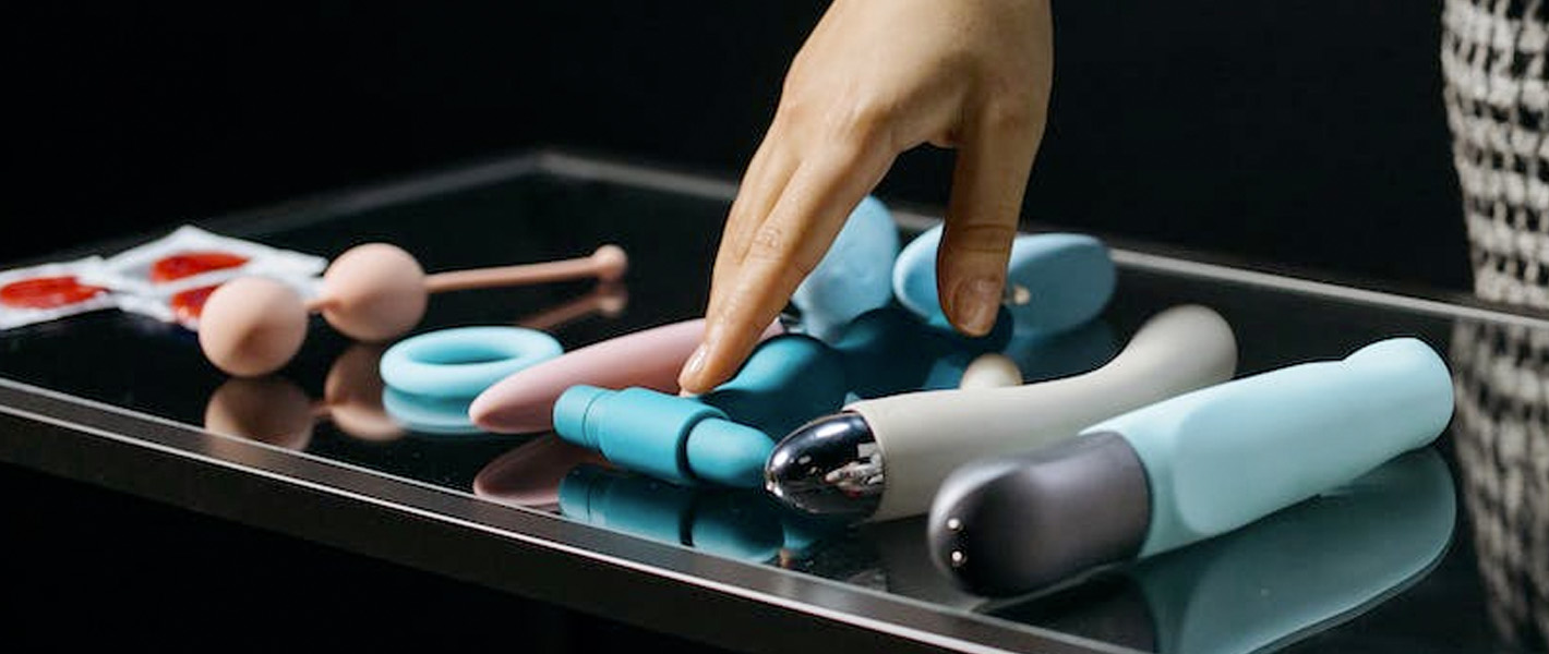 hand hovering over sex toys