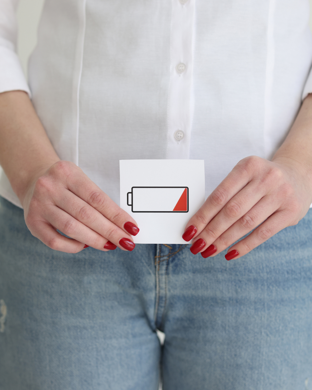 Woman holding a card showing a low battery